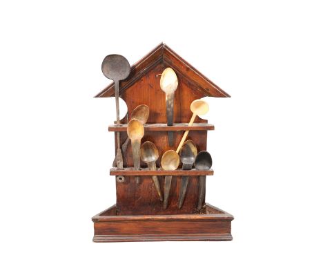 AN 18TH CENTURY PINE SPOON RACK, with pointed pediment, with seven horn spoons, iron ladle and a wooden ladle. 61cm highProve