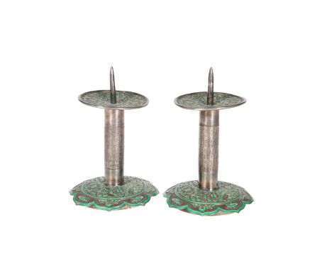 A PAIR OF PERSIAN GREEN ENAMEL AND WHITE METAL PRICKET STICKS, each with leaf-shaped base and circular drip pan above a cylin