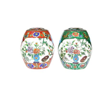 TWO CHINESE ENAMEL VASES, barrel-shaped with domed pierced cover, each painted with a vase of flowers to opposing reserves, t