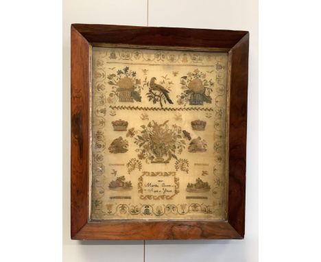 A rosewood framed sampler, dated 1842, by Martha Brook, aged 11years, worked above with large motifs of flower baskets and a 