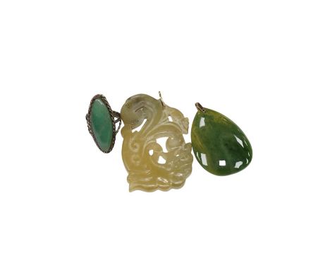 Two jade pendants including a carved example and a jade marquise ring, largest 6.5cm wide. Condition - fair to good