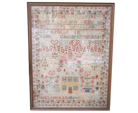 A large framed cross stitch sampler, by Helen Rae, dated 1851, worked mostly in red and green, with an ornate floral border a