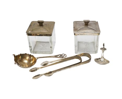 Two square silver topped glass preserve pot, two pairs of George III silver sugar tongs, a silver tea strainer and a caddy sp