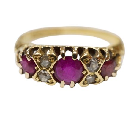 A George V 18ct gold and three stone ruby set half hoop ring, with diamond chip spacers, (one stone is probably a paste repla