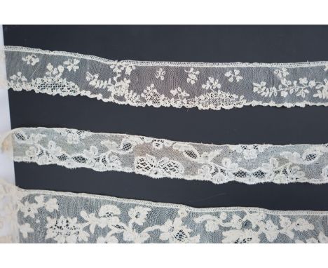 A large section of an ornate 19th century Brussels bobbin lace wedding veil, with two finished edges and one cut edge togethe