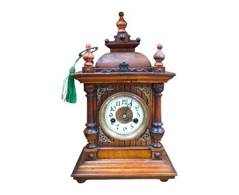 A late 19th century Black Forest walnut mantel clock with key and pendulum, 41cm. Condition - fair to good, not tested