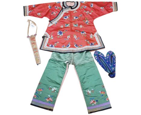 A Chinese embroidered fan case, a small red silk embroidered robe, trousers and a later pair of embroidered slippers, the rob