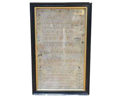 A framed cross stitch, alphabet sampler, by Kathleen Pearson, aged 8, dated 1911, worked in cross stitch with a decorative bo