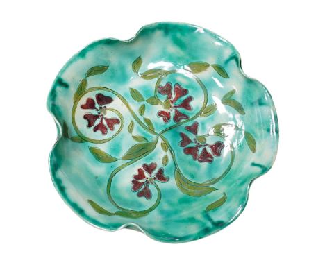 A Della Robbia green glazed floral dish, 19cm diameter. Condition - good.