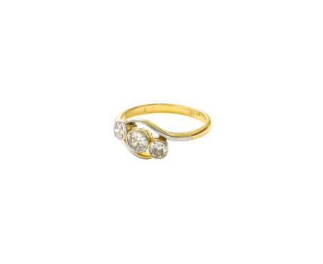 A Diamond Three Stone Twist Ring, the graduated round brilliant cut diamonds in white rubbed over settings, with a white fron