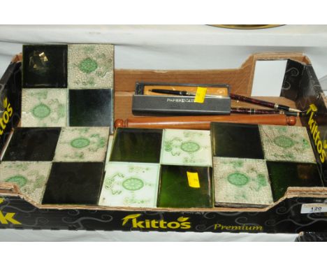 Box of decorative tiles and vintage pens 