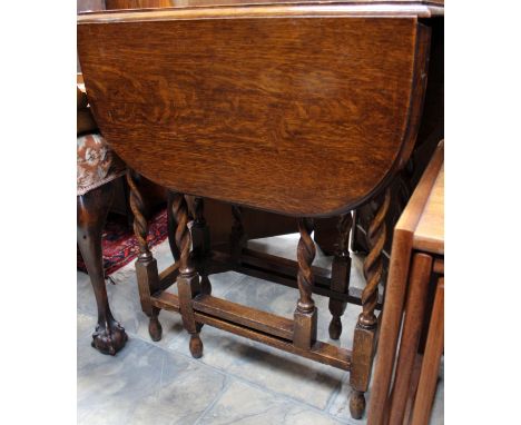 An early 19th Century mahogany tripod wine table, the circular top raised on a hexagonal column, standing on three shaped leg