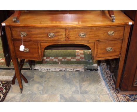 An Edwardian mahogany writing desk, in the manner of George Hepplewhite, bow fronted form, fitted with two long over two shor