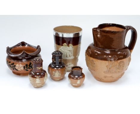 A late Victorian silver mounted Doulton stoneware beaker, London 1898, together with two similar pepperettes, a jug, a miniat