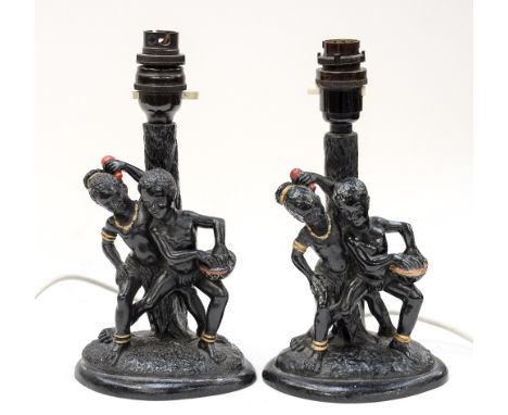Two circa 1950s black lamp bases, with black boy and girl in native attire, dancing around palm tree 
