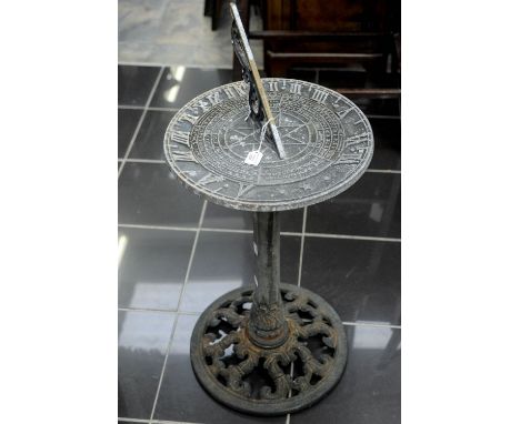 A modern painted aluminium sundial on a cast metal base