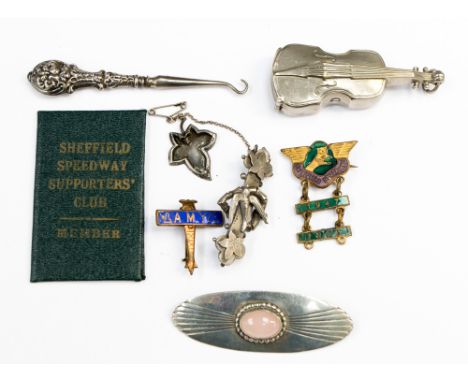 A collection of silver and white metal brooches, pins and button hook including an Amy Johnson Commemorative pin in the form 