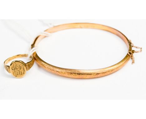 A 9ct gold hinged bangle together with a 9ct gold signet ring, monogrammed initials (2) 