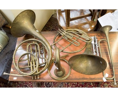 Two early piston valve French horns, bugle, trumpet and metal clarinet