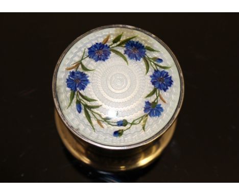 Scottish interest: a silver cylindrical trinket box, the cover applied with a thistle in a beaded border, 2.5cm high, 1.22ozt