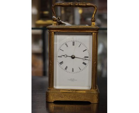 A carriage clock, retailed by Grohe, London, bright cut gilt metal corniche case, bell striking mechanism (key) 