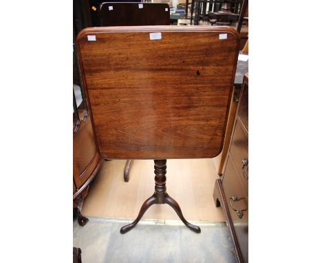 An early to mid 19th Century mahogany tilt top tripod table, raised on a turned column, standing on cabriole legs