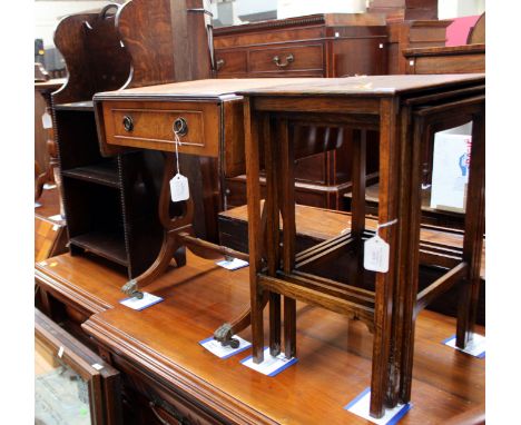 A collection of furniture comprising two tripod tables, an oak paper rack, a small burr walnut veneered sofa table and a nest