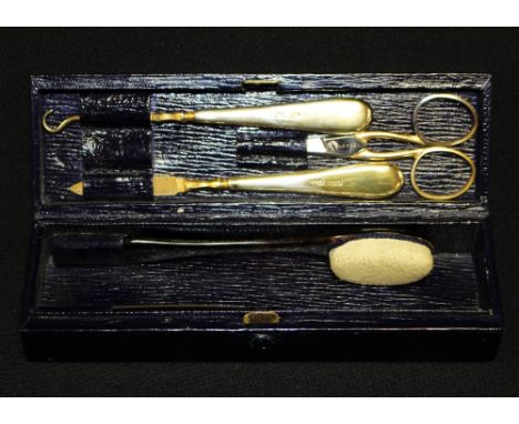 Asprey cased silver-gilt manicure set, comprising scissors, file, button hook, tortoiseshell effect buffer and file, in a blu