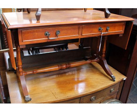 A modern yew veneered sofa table, fitted with two drawers