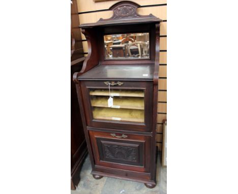 An Edwardian mahogany music cabinet, mirror to back, having a glazed door enclosing fitted shelves, with a manuscript compart