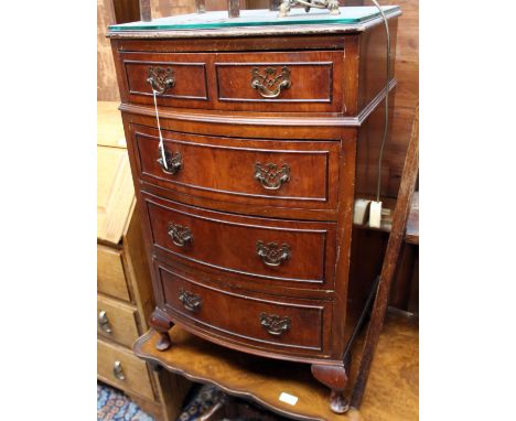 A Georgian style burr walnut veneered chest of drawers, bow fronted, together with a walnut veneered double pedestal coffee t