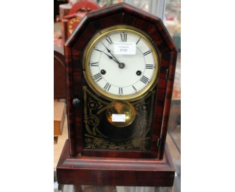 An early 20th century walnut veneered eight day mantle clock, with a white dial and black Roman numerals