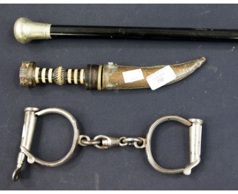 An ebonized walking stick, a pair of hand-cuffs (with key) and native knife (3)