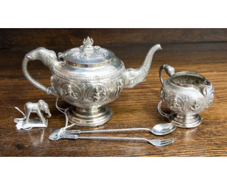 Indian teapot and matching cream jug, together with a miniature figure of an elephant and a pickle spoon and fork with elepha