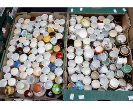 Two boxes of ceramic egg cups, including Royalty interest, various Devon potteries, souvenirs etc (two boxes) 