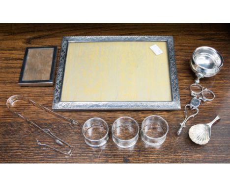 Three napkin rings, 1.9 ozt approx. Birmingham 1905 and Chester, silver frame, small Birmingham 1928, a white metal large fra