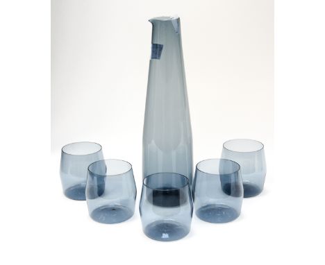 A Scandinavian Timo Sarpenera water set, comprising one water flask and five glasses, in smoked grey 