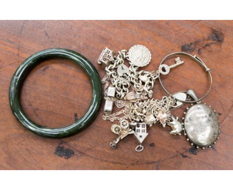 A silver charm bracelet, locket etc, with jade bangle 