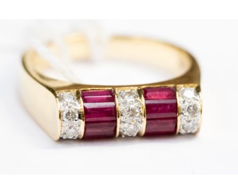 A ruby and diamond set 18ct gold ring, the round front containing small round brilliant cut diamonds and baguette rubies 