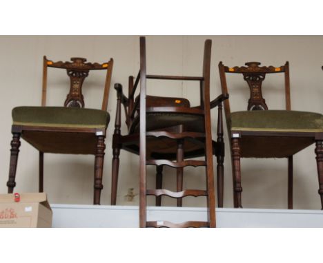 A late Victorian part salon suite, comprising three rosewood side chairs, with inlaid backs, over-stuffed seats, plus a ladie