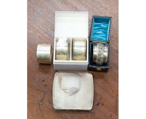 A pair of boxed oval silver napkin rings, engraved with initials, maker JR, Birmingham 1927, together with two circular silve