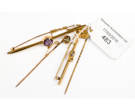 A Sri Lanka (Ceylon) sapphire gold, two small seed pearls, a peridot and gold stick pin and a gilt metal stick pin 