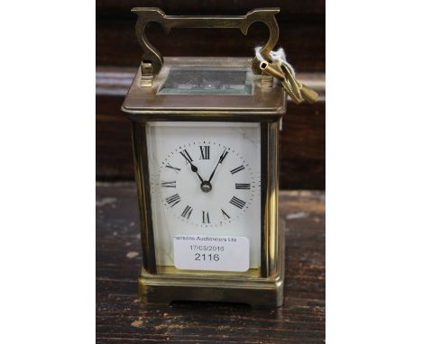 An early 20th Century brass carriage clock possibly French (no markings) enamel dial af, with key