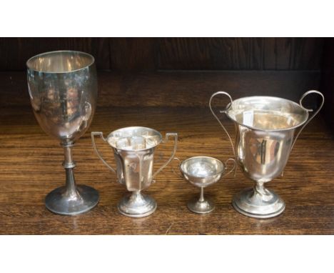 Three 20th Century silver trophy cups, each with detachable base, various dates and makers, height of tallest 14 cm, plus a W