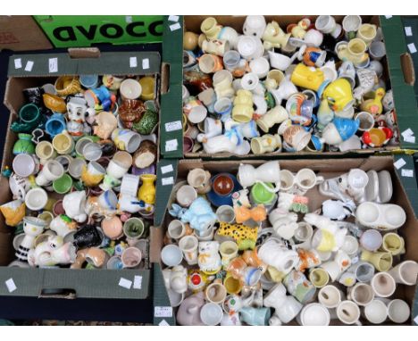 Three boxes of ceramic egg cups, mostly novelty designs, including animals 'His and Hers', etc (three boxes) 