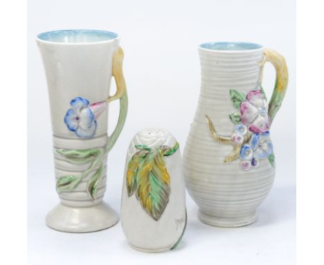 Clarice Cliff for Newport Pottery, two relief moulded vessels, the jug of baluster form, the handle modelled as a flowering b