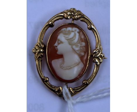 A 9ct gold cameo brooch, depicting bust portrait of a lady in openwork gold scroll  mount 