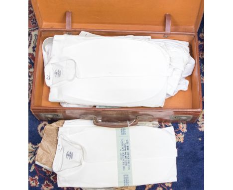 A suitcase containing vintage white shirts