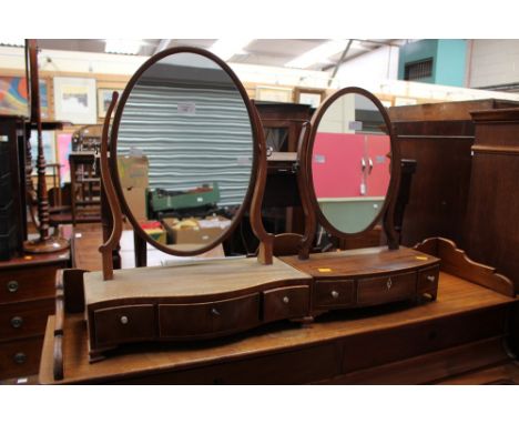 A George III mahogany toilet mirror, circa 1810, the adjustable oval mirror with parquetry stringing, secured on shaped suppo