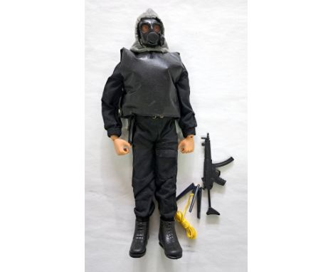 Palitoy Action Man SAS, brown flock hair and beard, blue pants, eagle-eyes, gripping hands, wearing jump-suit and hood, boots